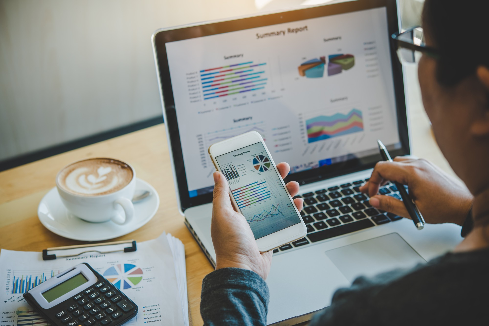 businessmen-use-smartphones-and-laptop-to-connect-and-find-information-in-office