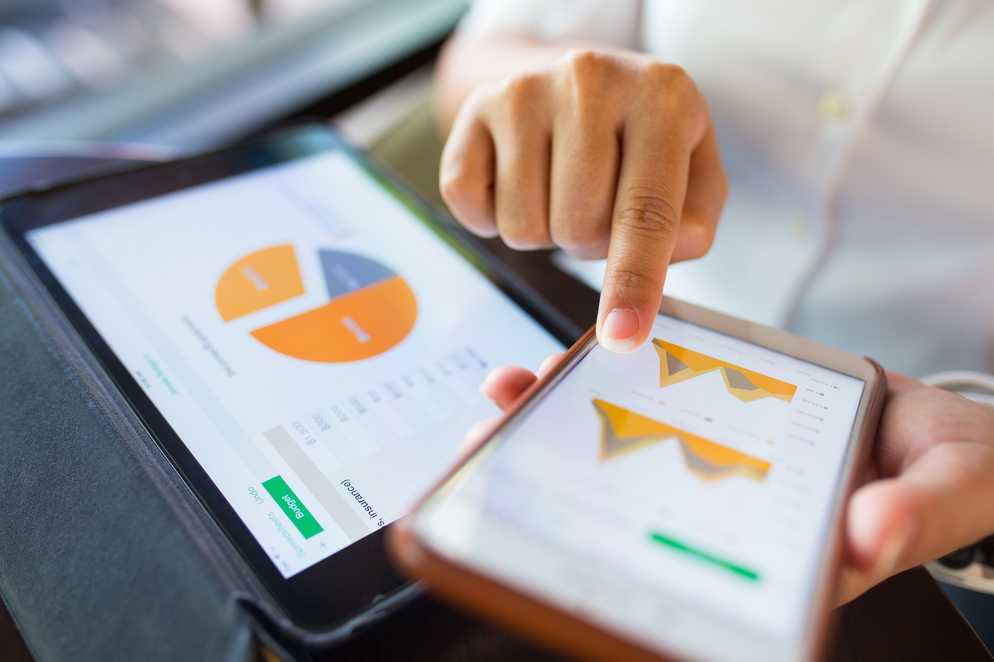 businesswoman-check-data-in-smartphone-and-tablet